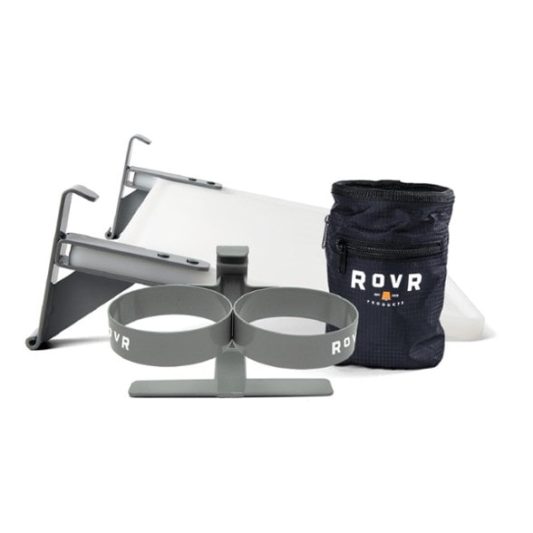 Top-down view of camping cooler kit showing prep board and drink holder in use outdoors