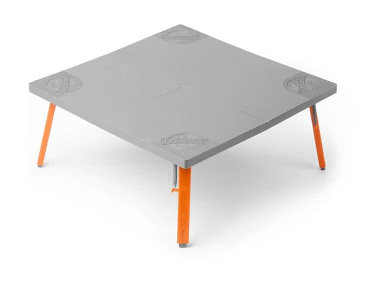 Compact Adventure Folding Table set up at a picnic site with food and drinks.