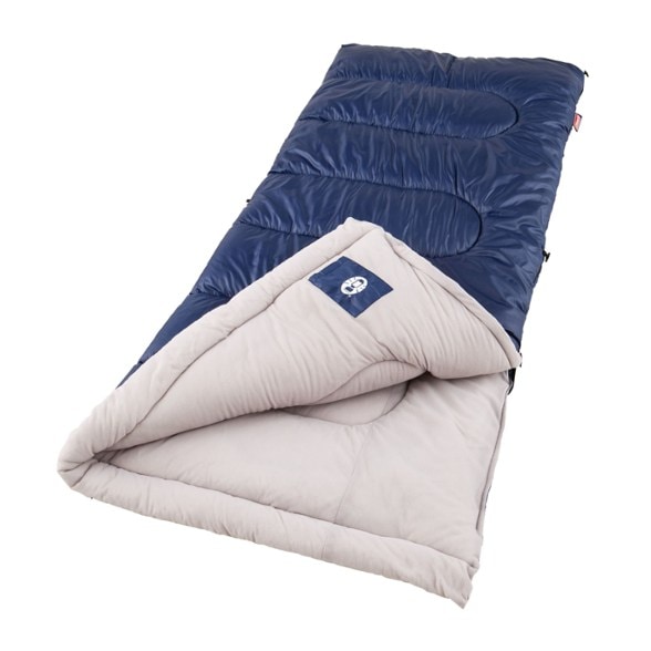 Coleman Brazos sleeping bag in a campsite setting, showcasing its vibrant colors and durable fabric.