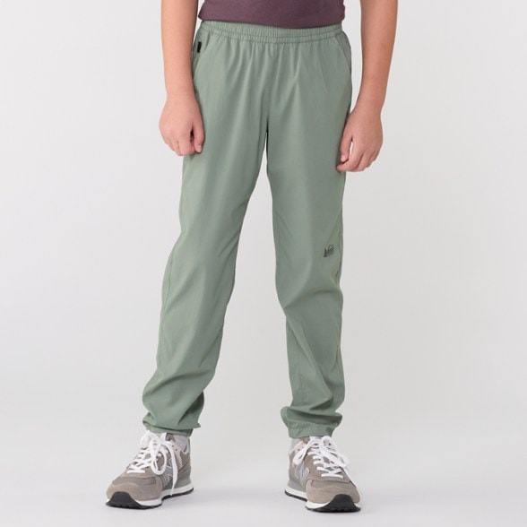 Front view of REI Co-op TrailFlex kids hiking pants showing stretchy breathable fabric and water repellent finish