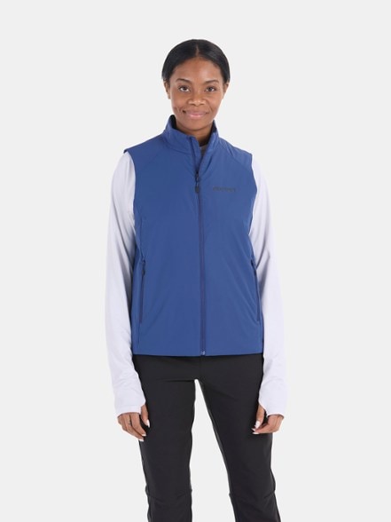 Marmot Novus LT Women's PrimaLoft Insulated Vest in action during a winter hike, emphasizing its warmth and mobility.