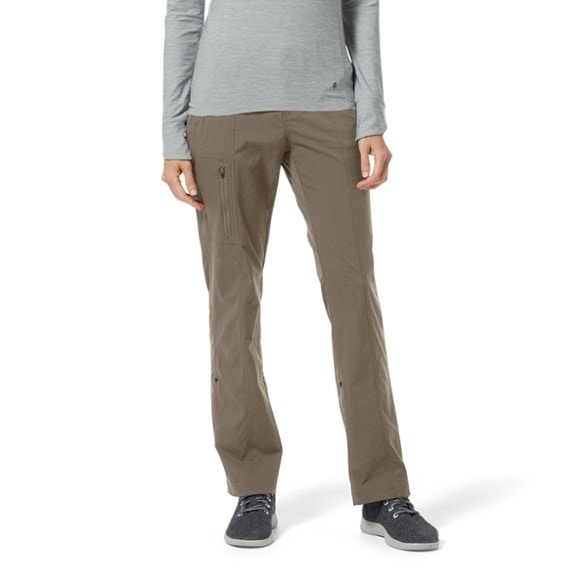 Royal Robbins women's hiking pants with rolled-up legs showcasing their capri style in a forest setting.
