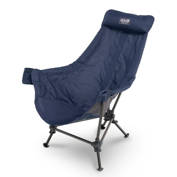 Eco-Luxe Lounge Chair in a serene camping setting, featuring cushioned armrests and adjustable legs for ultimate comfort.