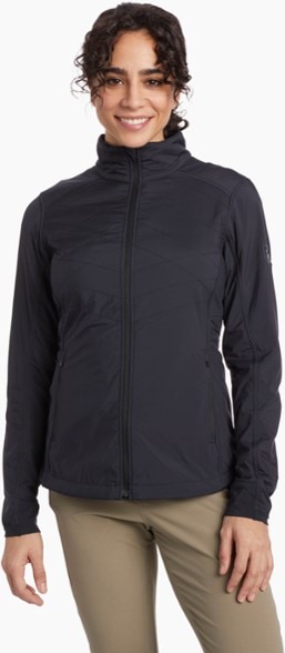 AeroFlex Women's Insulated Jacket on a hiker in a snowy landscape, highlighting its windproof features.