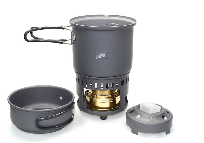 Compact trekking cookset displayed outdoors with a scenic backdrop