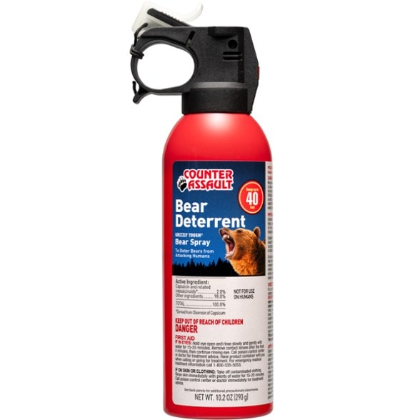 Ultimate Bear Spray showing atomized spray distance and safety features.