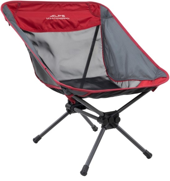 Adventure Ready folding chair set up in a camp site with mountains in the background.