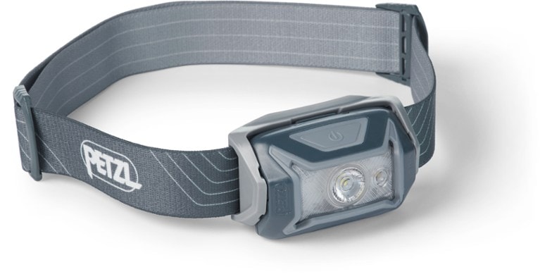 Petzl Tikka LED headlamp showing its compact design and red light mode during camping.
