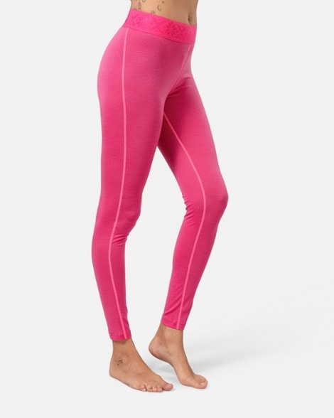 Kari Traa Lucie base layer pants in a winter outdoor setting, highlighting their slim fit and merino wool fabric.