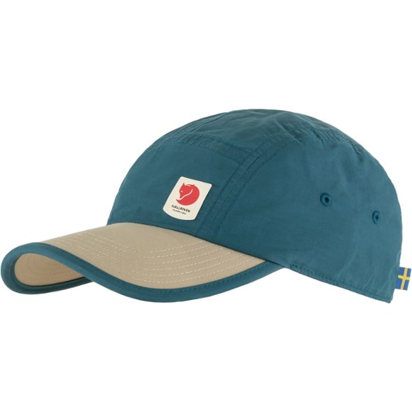 Breezy Adventure Cap shown outdoors with a scenic background, highlighting its ventilation eyelets.