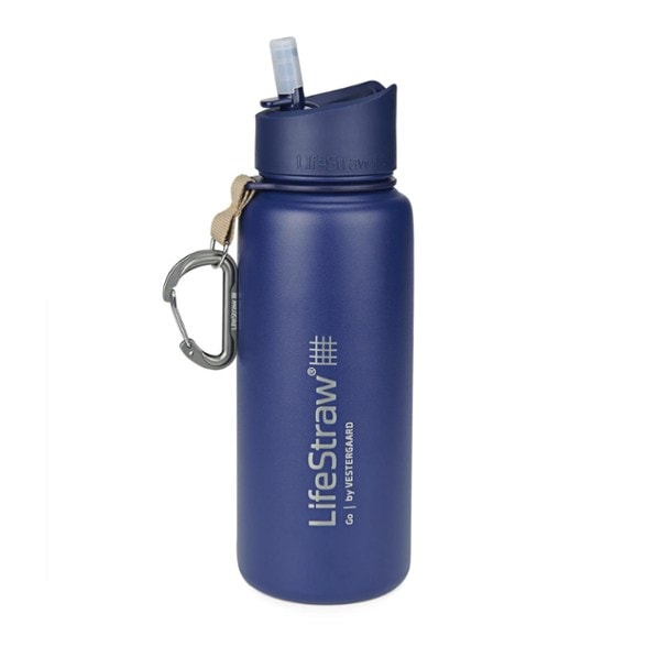 Stainless steel water filter bottle on a hiking trail, showcasing its durability and design.