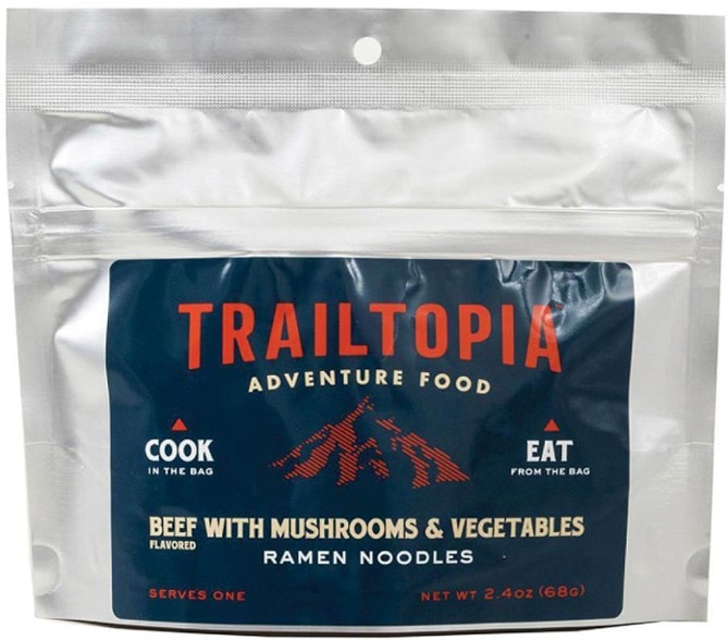Trailtopia beef ramen noodles cooked and served outdoors, showing vibrant vegetables.