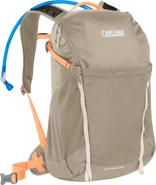 CamelBak Rim Runner X20 women's hydration pack in action on a hiking trail.