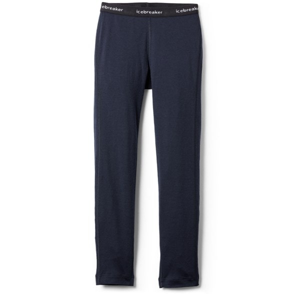 Front view of kids wearing Oasis Merino base layer leggings for winter sports.