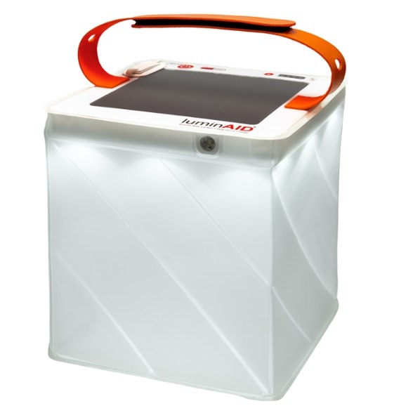 LuminAid Survivor Quick Inflate Solar Lantern with phone charger displayed outdoors, highlighting its compact design.