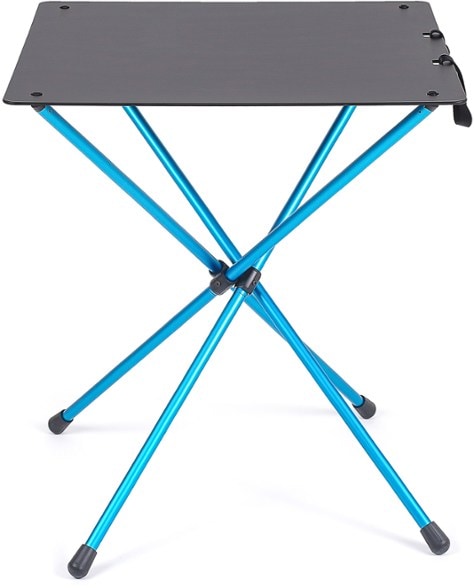 Side-angle view of the camping table set up next to chairs under a tree canopy