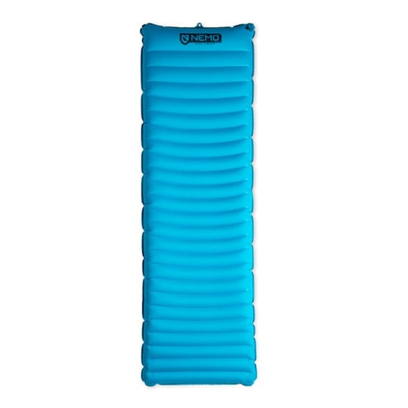 Quasar 3D Lightweight Sleeping Pad displayed outdoors, showcasing its design and features.