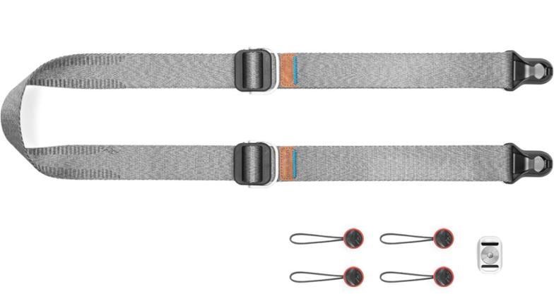 Peak Design Slide Lite 2.0 camera strap displayed in sling mode against a scenic backdrop.