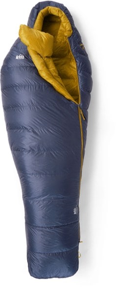 Lightweight Down 30 Backpacking Sleeping Bag in a forest setting, highlighting its compact size.