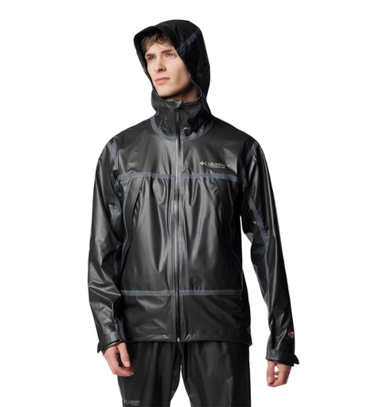 Men's packable shell jacket in the wilderness, demonstrating its waterproof capabilities.