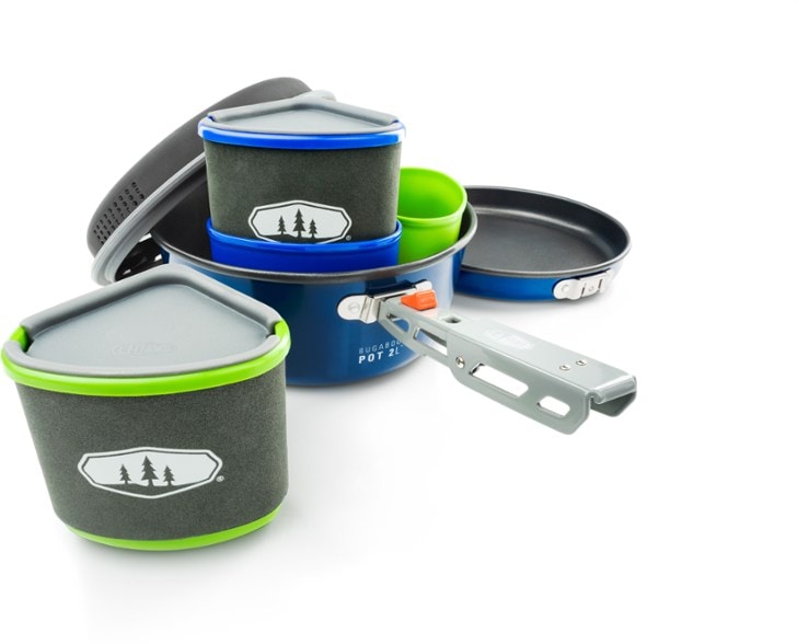 TrailBlazer Lightweight Ceramic Cookset displayed with bowls and mugs in a scenic camping setting.