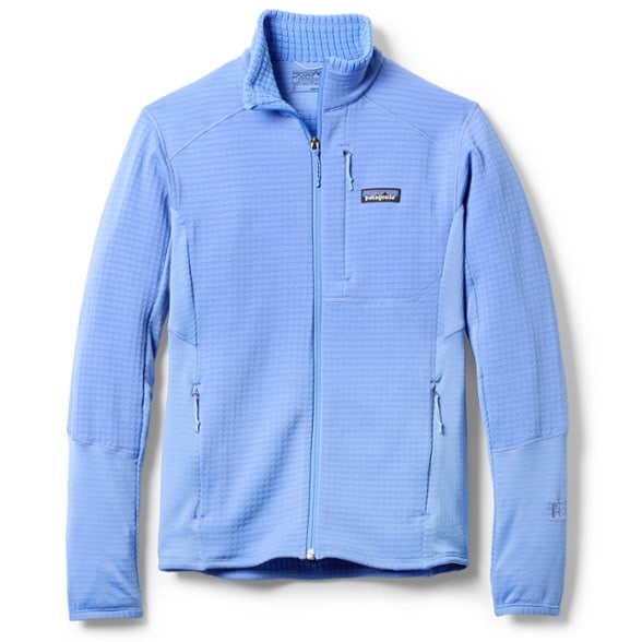 Patagonia Women's R1 Hybrid Jacket displayed with a scenic mountain backdrop, emphasizing its outdoor versatility.