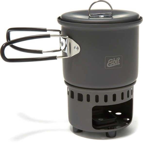 Esbit solid fuel stove set up with pot and fuel tablets in a campsite