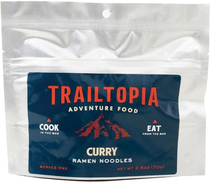 Trailtopia spicy ramen noodles bowl with vibrant curry sauce and fresh vegetables, ready to eat outdoors