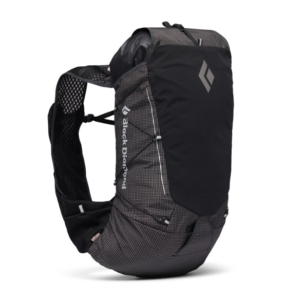 Mountain Trail 22 backpack in use during a mountain run, showcasing its sleek design and fit.