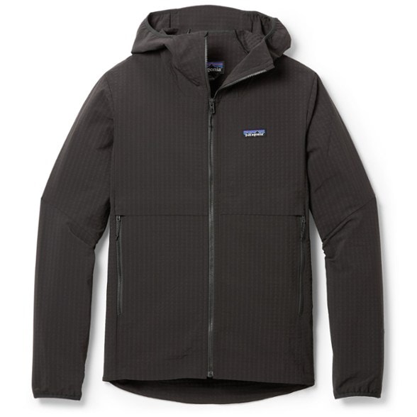 Men's R1 TechFace Hoody in action on a hiking trail, highlighting its weather resistance and flexibility.