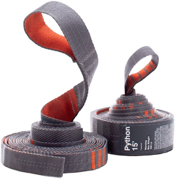 Close-up of variable-width hammock straps wrapped around a thick tree trunk with bark-friendly design