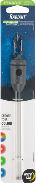Nite Ize Radiant rechargeable LED glow stick glowing in the dark at a campsite.