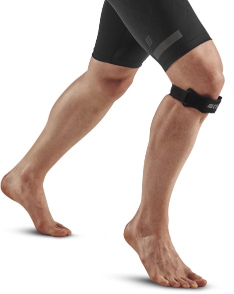 Side view of the Ultimate Patella Support Strap in use during a running session.