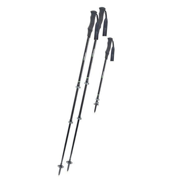 Close-up of Komperdell Trail UL carbon trekking poles on a forest trail, showcasing the foam grip and locking mechanism.