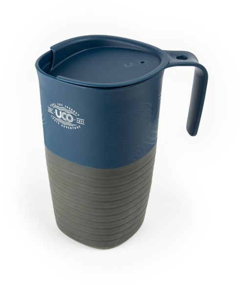Eco-friendly collapsible camping cup with a scenic mountain background.