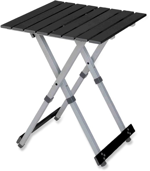 Side view of GCI Outdoor TrailMaster compact folding camp table showing aluminum tabletop and telescoping legs