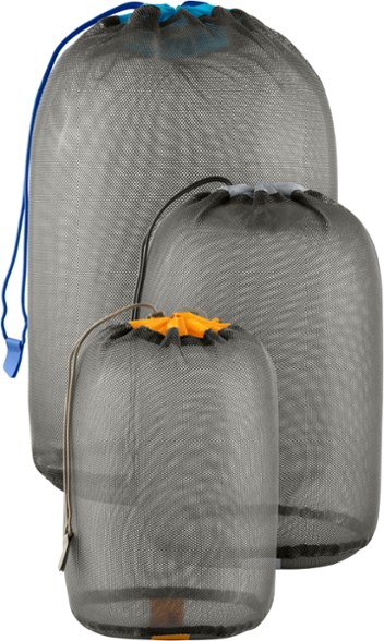 Small mesh stuff sack set against a nature background, showcasing durability and lightweight design.