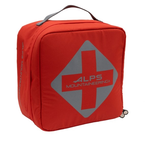 Compact outdoor medical kit attached to hiking backpack with elastic cords