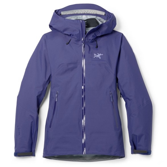 Alpine Shield Women's GORE-TEX Adventure Jacket displayed against a rocky backdrop, highlighting its windproof features.