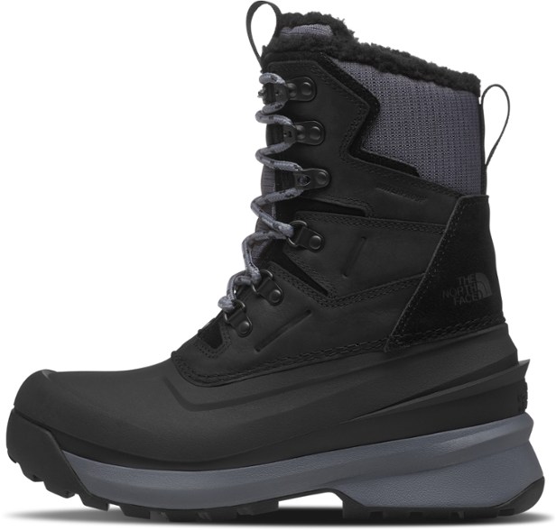 Close-up side view of waterproof boots showing rugged leather and fleece trim for cold weather durability.