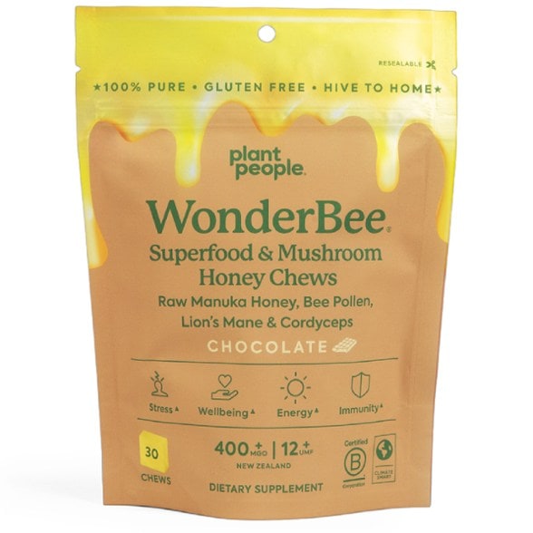 Revitalizing Superfood Honey Chews in a colorful packaging on a wooden table.