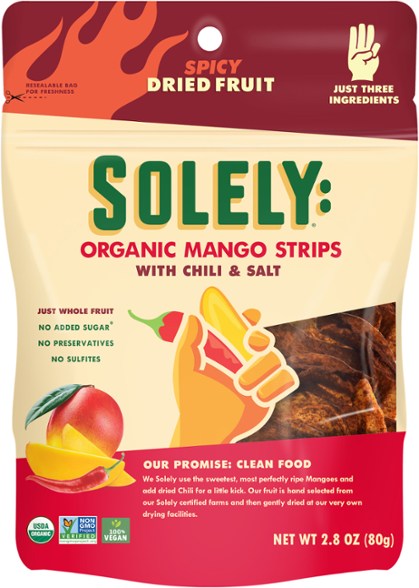 Top view of Chili Kiss dried fruit strips laid out with chili flakes, showing spicy texture
