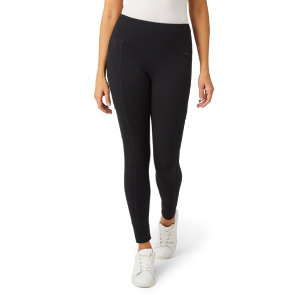 Women's trail tights showcasing water-repellent fabric and pockets for storage.