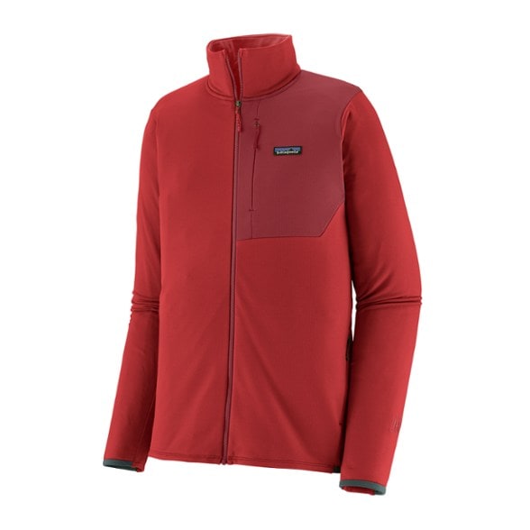 Men's Alpine Performance Thermal Jacket in action during a snowy hike, showcasing its warmth and flexibility.
