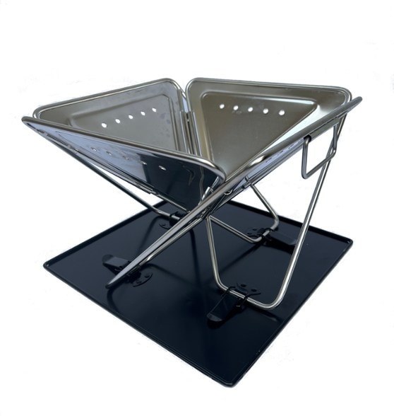 TOAKS Portable Fireplace set up in a backyard for outdoor cooking.