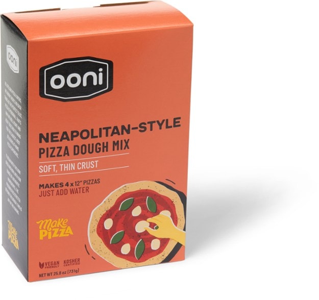 Ooni Neapolitan pizza dough mix package with pizzas on a wooden table