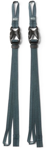 REI Packmod gear attachment straps displayed with hiking gear, showcasing their versatility.