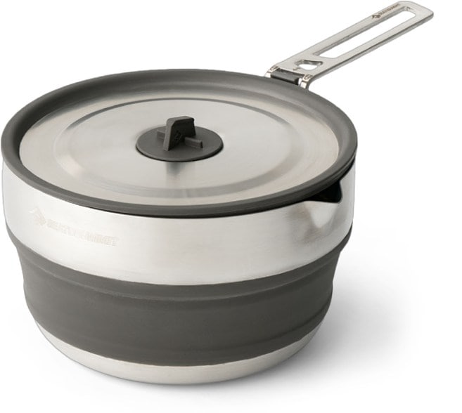 Versatile stainless steel camping pot with lid at a campsite