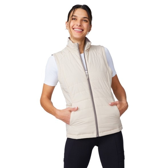 Front view of women's reversible insulated vest in hiking setting.