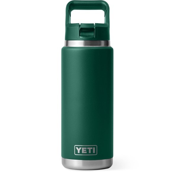 Side view of YETI 26 oz vacuum water bottle with straw on a sandy beach